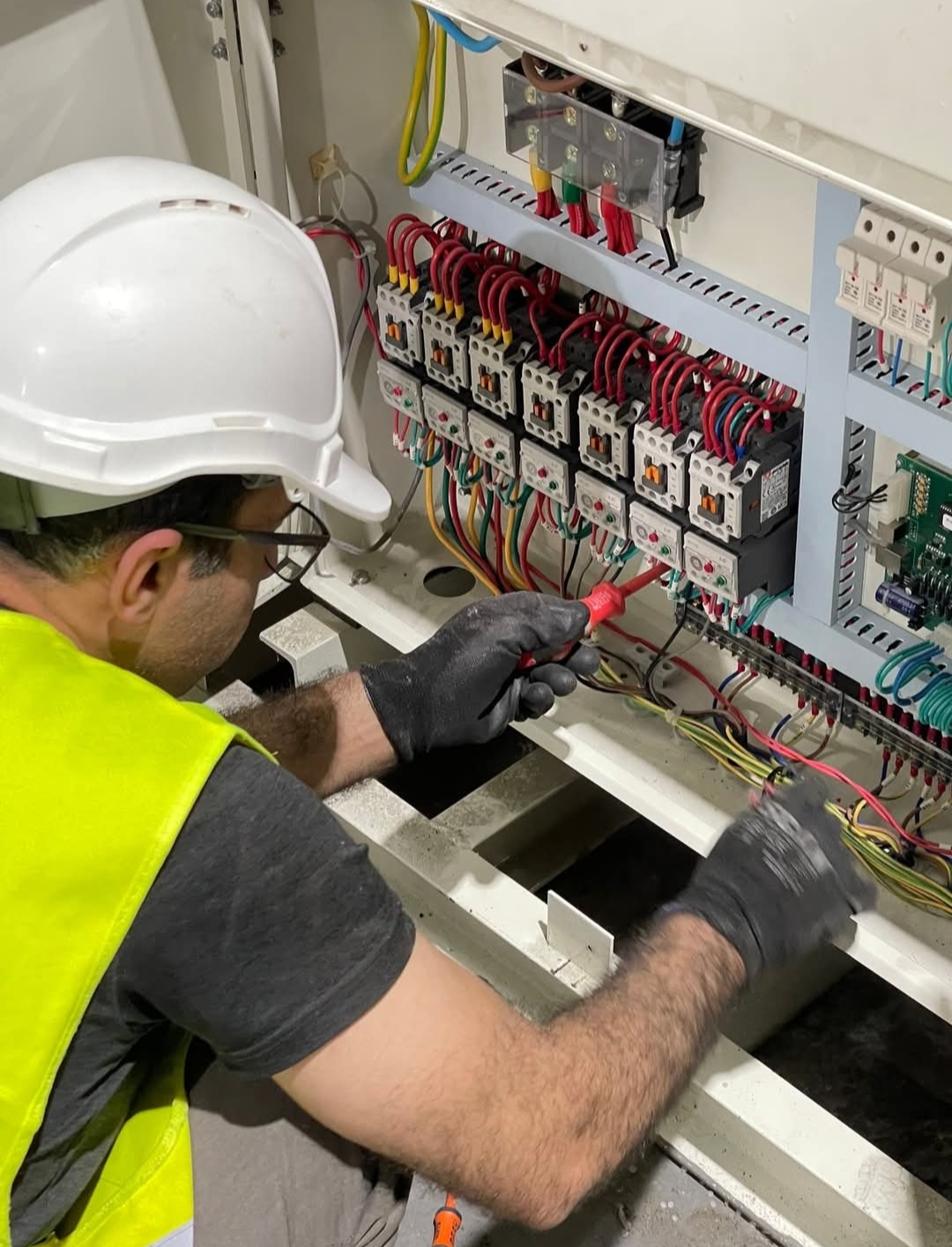Electrician working on an industrial panel